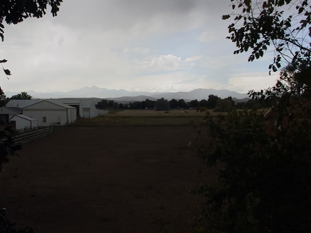 A dirt field with mountains in the distance