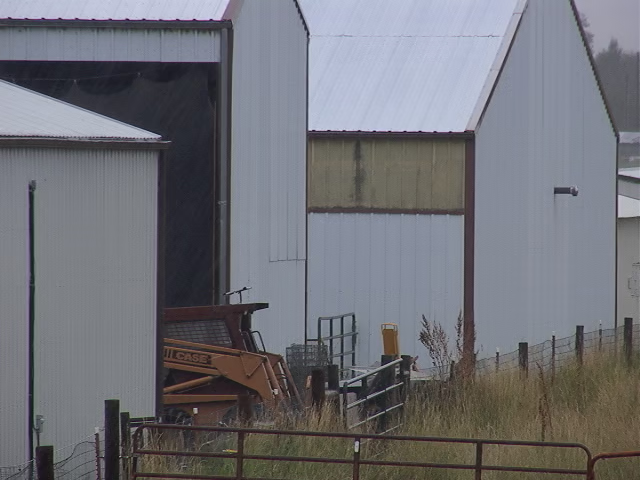 White metal buildings in the rain